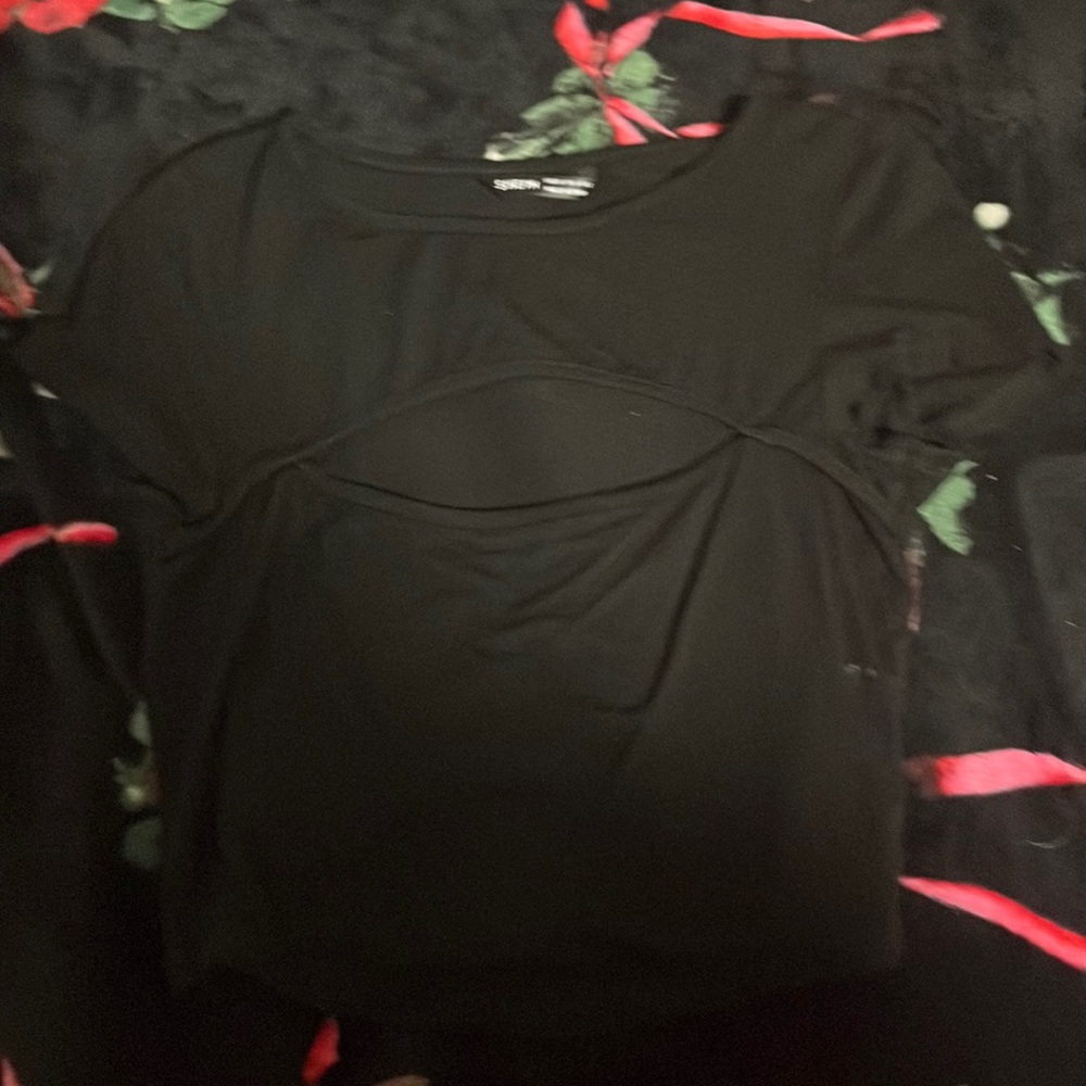 It is a black soft short sleeve open cut top.